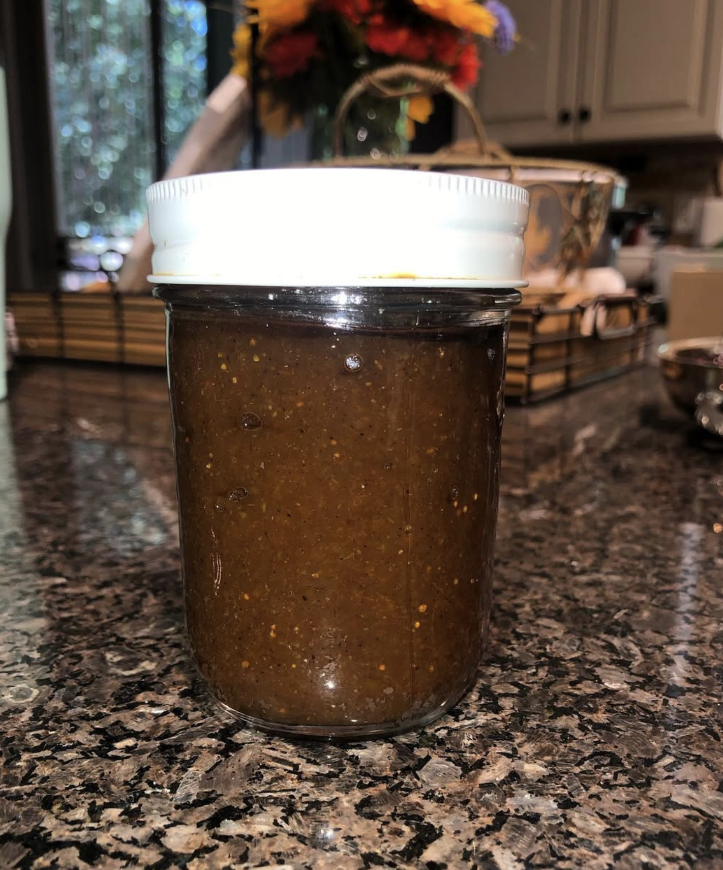 photo of an unlabeled jar of salsa on a kitchen counter